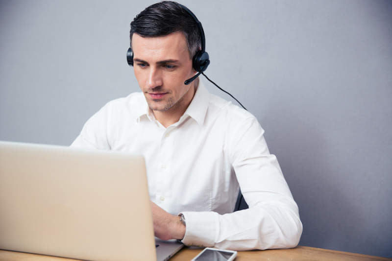 Photo of a man in front a computer